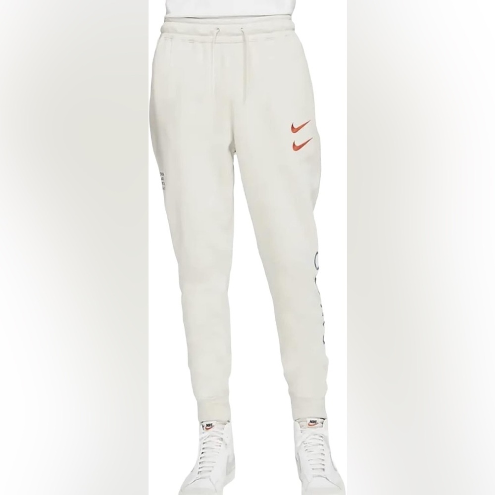 Nike Kids Cream Joggers with Red Swoosh and Blue Lettering